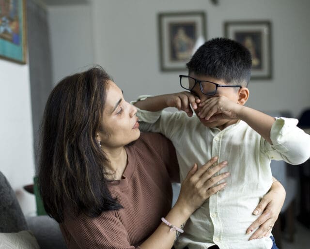 mom comforting a crying little boy