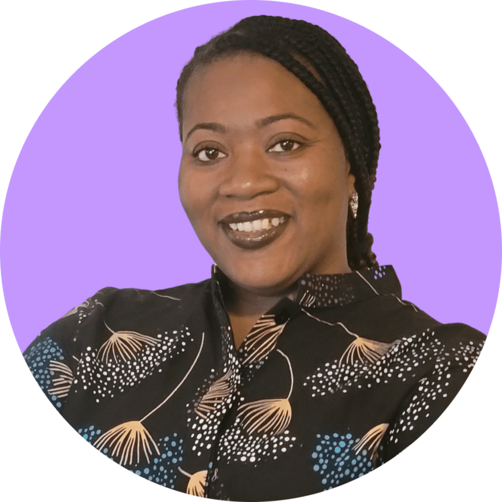 Photo of Ciandra St. Kitts, LCSW. Ciandra is smiling and wearing a black collared blouse with beige, white, and blue designs. Ciandra is a black woman with brown eyes and brown/black braids pulled back in a low ponytail. This photo is set against a lavender color circular purple backdrop.