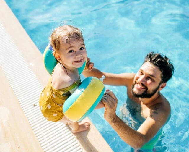 father and young daughter in pool