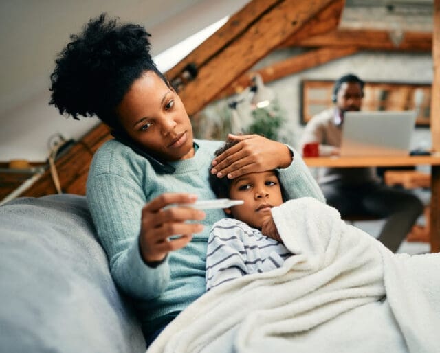 Mother taking care of a child with a fever