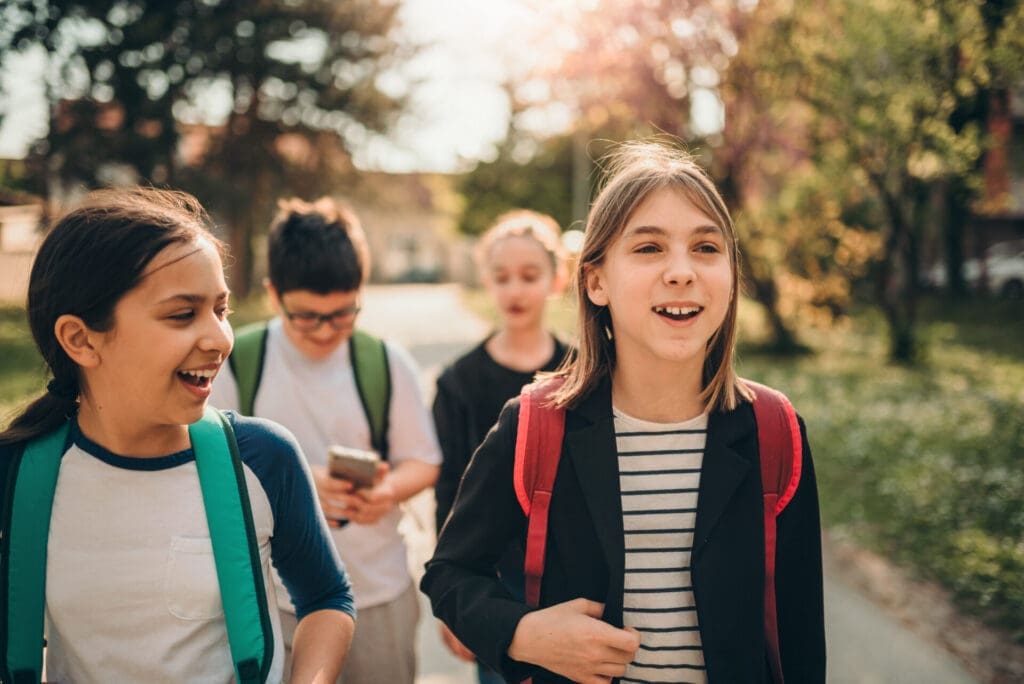 middle-schoolers walking, talking, and laughing together