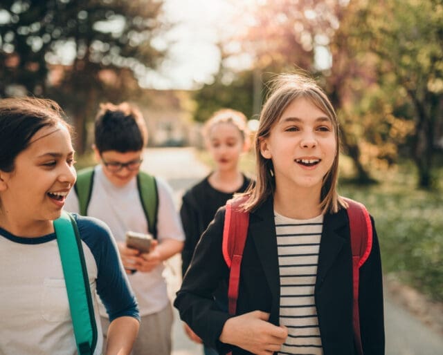 middle-schoolers walking, talking, and laughing together