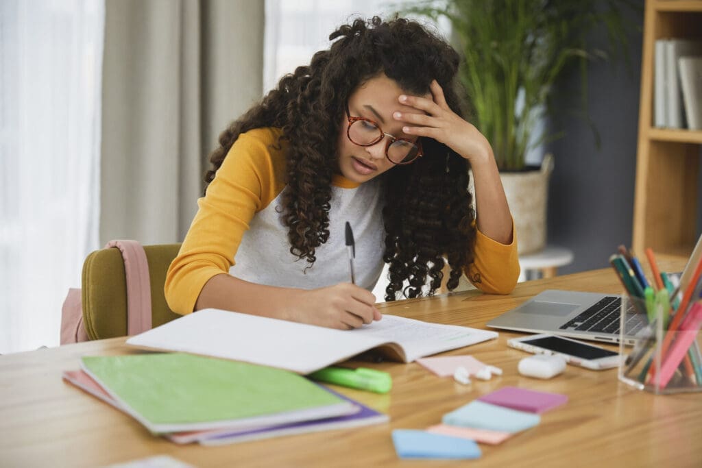 Teenage girl studying, looking stressed out