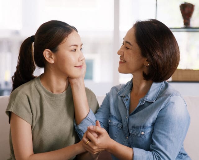 Middle aged asia people old mom love care trust comfort help young teen talk crying stress relief at home. Mum as friend listen adult child woman feel pain sad worry of broken heart life crisis issues