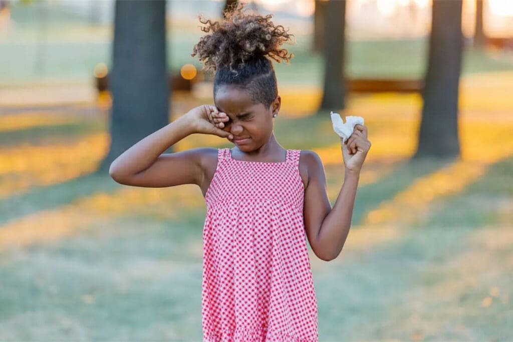 Little girl rubbing her eyes